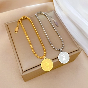 Minimalist titanium steel beaded bracelet with vintage Elizabeth II coin pendant in gold and silver
