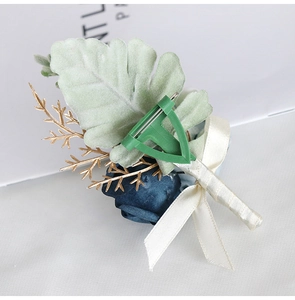 Close-up of velvet rose boutonniere back with T-pin fastener and silk ribbon detail