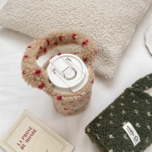 Close-up of thick plush teddy fleece cup sleeves with red and white dot patterns