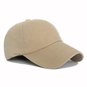 Close-up of the washed cotton fabric texture and sturdy stitching on a khaki baseball cap