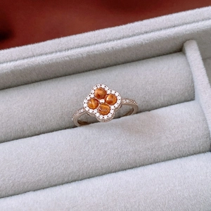 Macro shot of vintage tiger eye clover ring on velvet, showing fine metal details