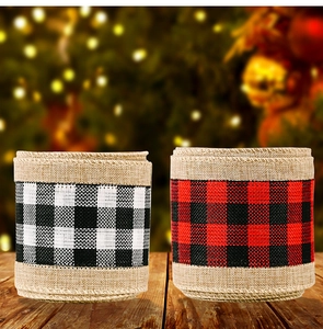 Close-up of rustic buffalo plaid linen ribbons on a wooden surface with festive lights