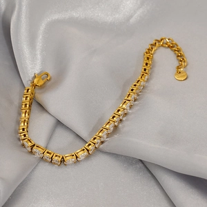 Detail of gold-plated stainless steel tennis bracelet with white oval cubic zirconia