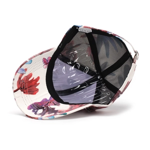 Detail view of floral baseball cap interior featuring breathable black mesh and care label