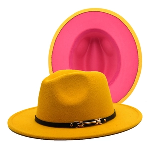 Detail of yellow wool fedora hat with black leather belt buckle and pink lining
