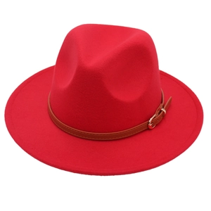 Detail of red wool fedora hat featuring a brown leather belt strap with gold buckle