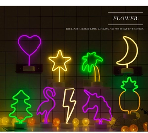 Various LED neon sign lights including flamingo and pineapple shapes with round base stand