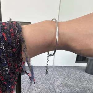 Minimalist S925 sterling silver geometric bracelet featuring cross charm on model wrist