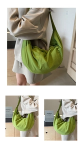 Detail of the green large nylon dumpling bag showing high-capacity texture on the model