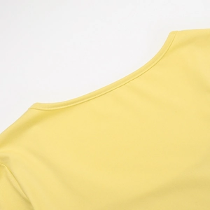 Detail of yellow knit square neck top showing neckline craftsmanship and shoulder stitching