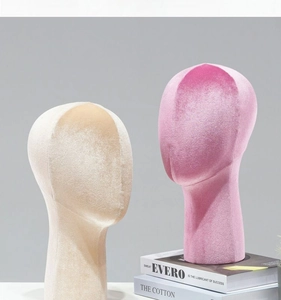 Detailed view of beige and pink velvet mannequin heads for wig and hat display