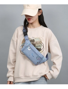 Close-up of blue Oxford fabric waist bag with reflective pattern and zipper pockets