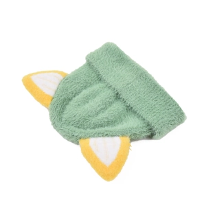 Detail of light green plush knitted hat with cute yellow cat ears and soft texture