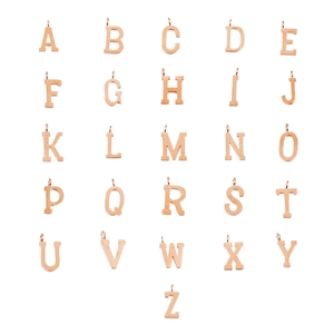 Macro shot of 26 alphabet charms set in rose gold finish stainless steel material