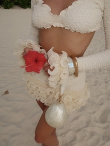 Close-up of white bubble texture fabric and ruffled cuffs on this long sleeve resort set