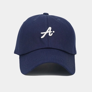 Close-up of navy blue baseball cap with white 3D embroidered letter A and curved brim