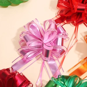 Detailed view of pink matte pull bows for gift wrapping with colorful ribbon options