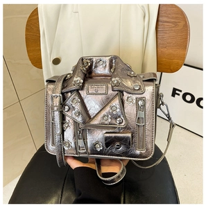 Detailed view of metallic silver motorcycle jacket bag with floral rhinestone studs