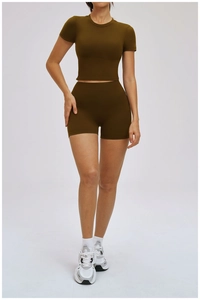 Front view of women's olive brown yoga set featuring crop top and high waist shorts
