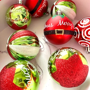 Close-up of 6cm red and green Christmas ball ornaments with glitter and matte finishes