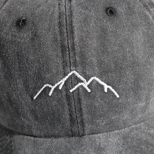 Unisex washed dark grey baseball cap featuring a minimalist white mountain line embroidery
