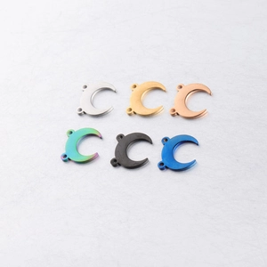 Detailed view of crescent moon steel charms in six colors including gold and rainbow finish