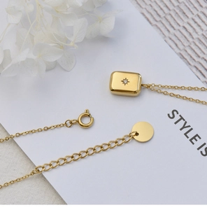 Detail showing the 18K gold plated octagonal star pendant with a clear zircon gemstone