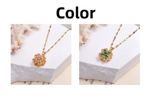 Detail of clover necklaces with pink and green zircon spinning pendants in gold finish