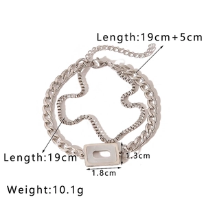 Detail of silver layered Cuban and box chain bracelet with rectangle geometric pendant
