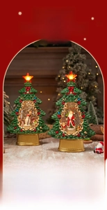 Close-up of glowing Christmas tree music box with Santa and snowman inside a snow globe