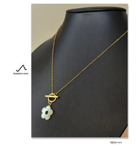 Detail of 18K gold plated stainless steel floral necklace with shell inlay and toggle clasp