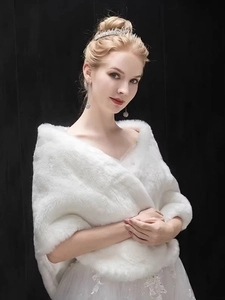 Close-up of soft white faux fur bridal shawl with premium texture for winter wedding dress