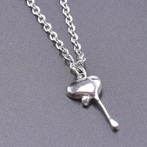 Macro shot of silver liquid lava heart pendant with minimalist O-chain necklace