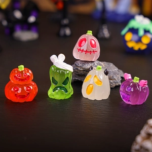 Five miniature Halloween resin figurines in vibrant translucent colors on dark surface
