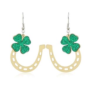 Detail of horseshoe earrings with green glitter shamrocks for St. Patrick's Day