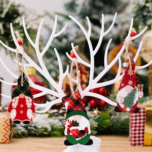 Detailed close-up of colorful wooden Christmas gnome ornaments hanging on a white branch