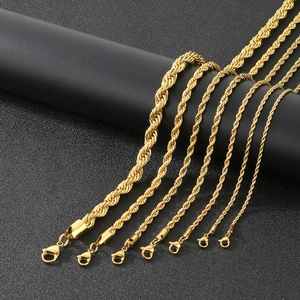 Detail of seven gold-plated twisted rope chains with secure lobster clasps on black surface