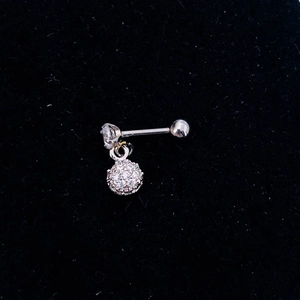 Macro view of silver stainless steel cartilage stud with clear gemstone and sphere pendant