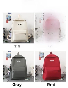 Detailed grid view of minimalist backpacks in four colors with astronaut pendants