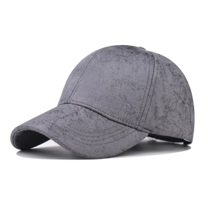 Detail of grey baseball cap showing marbled texture and stitching on suede fabric