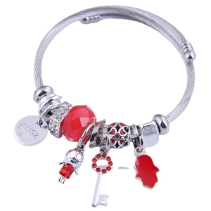 Silver beaded bracelet with red charms including a heart key and Hamsa hand on white background