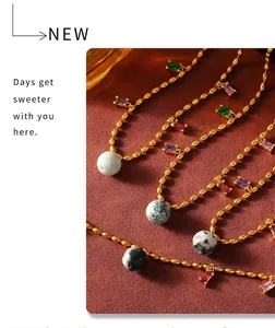 Détail du collier chaîne à billes dorées avec pierres colorées et perles marbrées