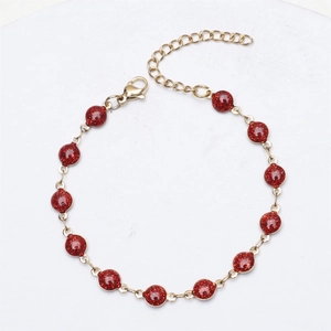 Detail of red glitter beads set in 18K gold plated stainless steel bracelet