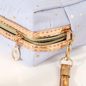 Light blue cosmetic bag with golden stars pattern and durable metal zipper closure