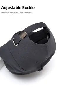 Detail of adjustable metal buckle and dark gray cotton fabric on a baseball cap