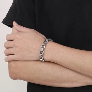 Detailed close-up of retro engraved patterns on a men's vintage stainless steel chain bracelet