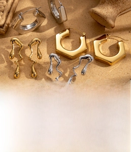 Detailed view of geometric hexagon and liquid metal teardrop titanium steel earrings