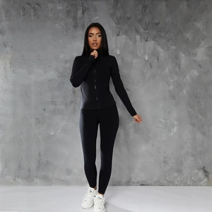 Close-up of black activewear set with zip-up jacket and high-waist yoga leggings