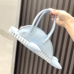 Creative blue whale-shaped handbag with unique striped belly and smooth PU leather finish