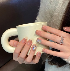 Handmade French nude press-on nails with silver glitter, large rhinestones, and bow decor